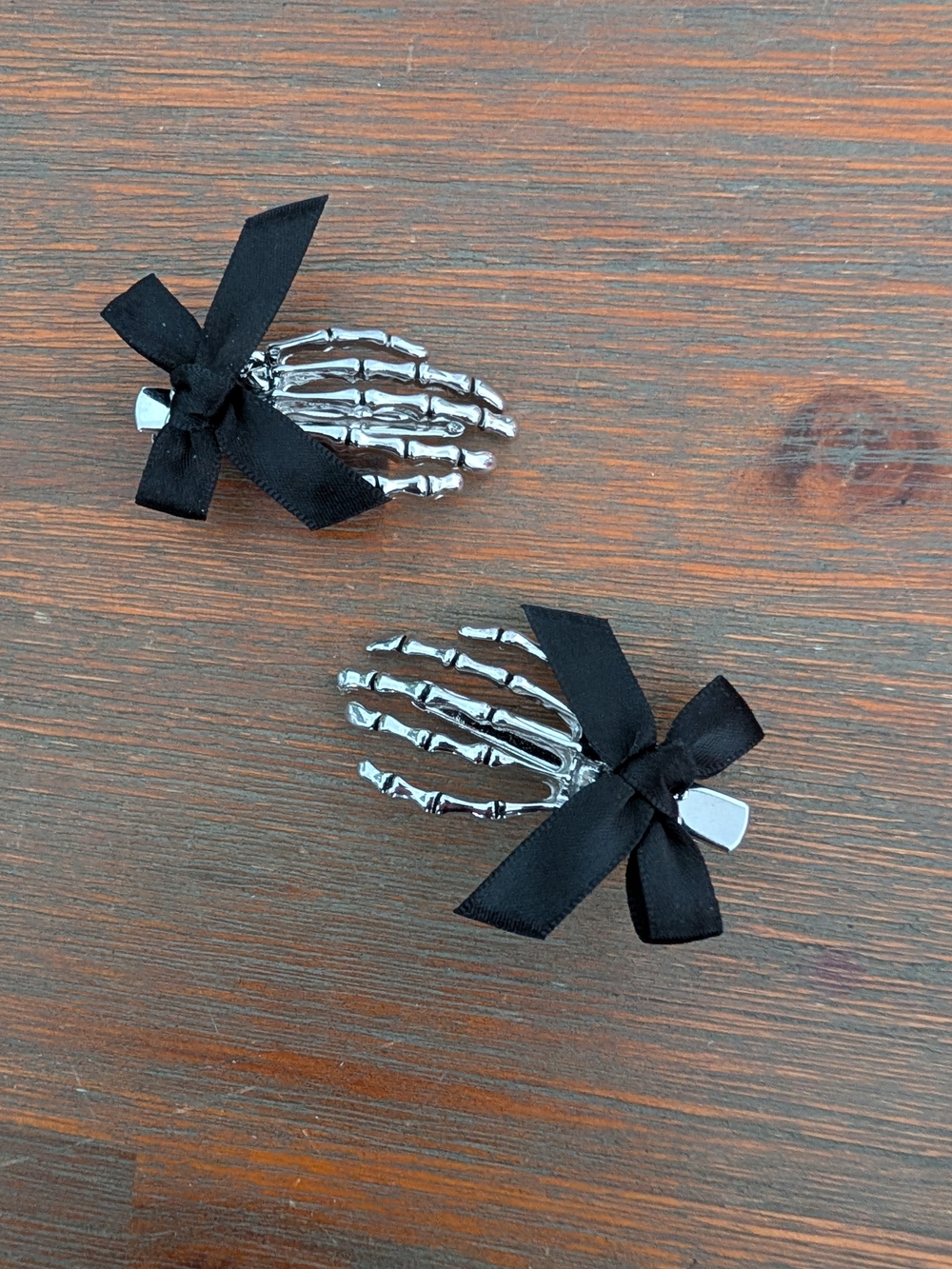 Claire's Silver Skeleton Hand Hair Clips with Black Bows